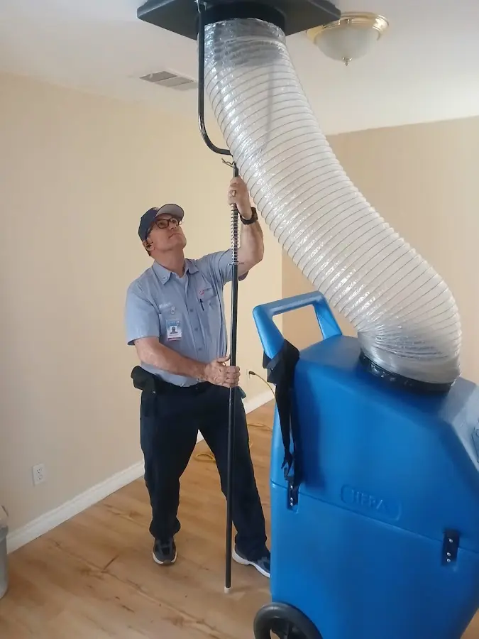 Furnace Tune-Up technician using HEPA equipment in Fayetteville
